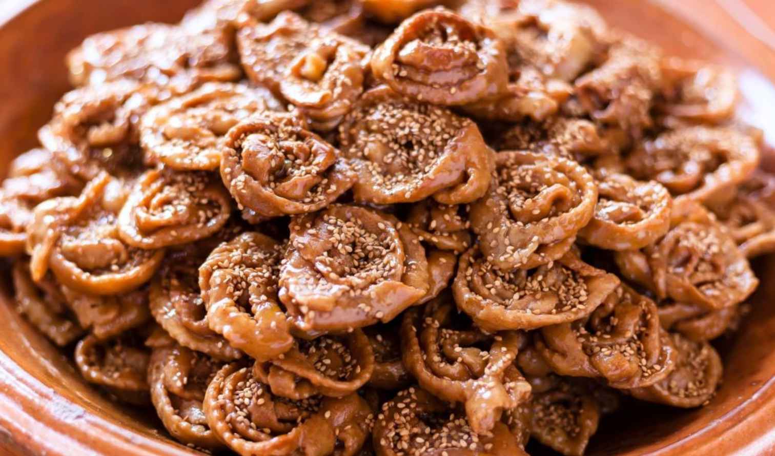 Close-up of Moroccan chebakia pastries topped with sesame seeds on a plate in Marrackech.