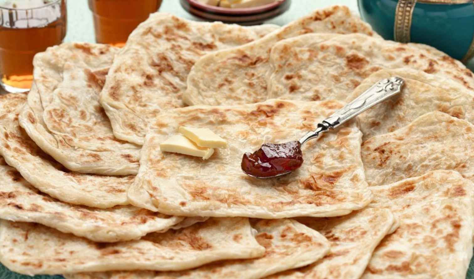 A stack of flatbreads with butter and jam on top in Marrackech