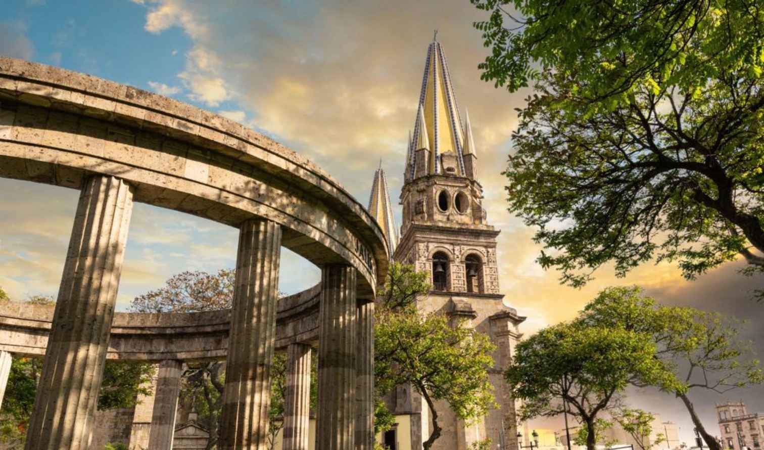 View of Guadalajara Cathedral's spires with nearby Rotonda monument.