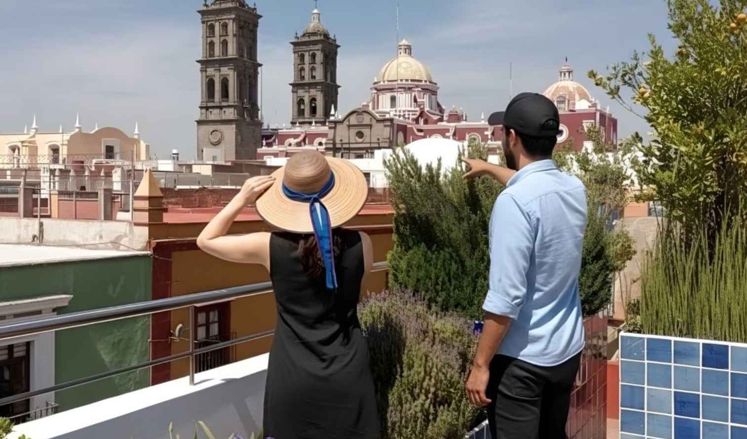 Two people on a rooftop viewing Puebla Cathedral towers, Puebla, Mexico.