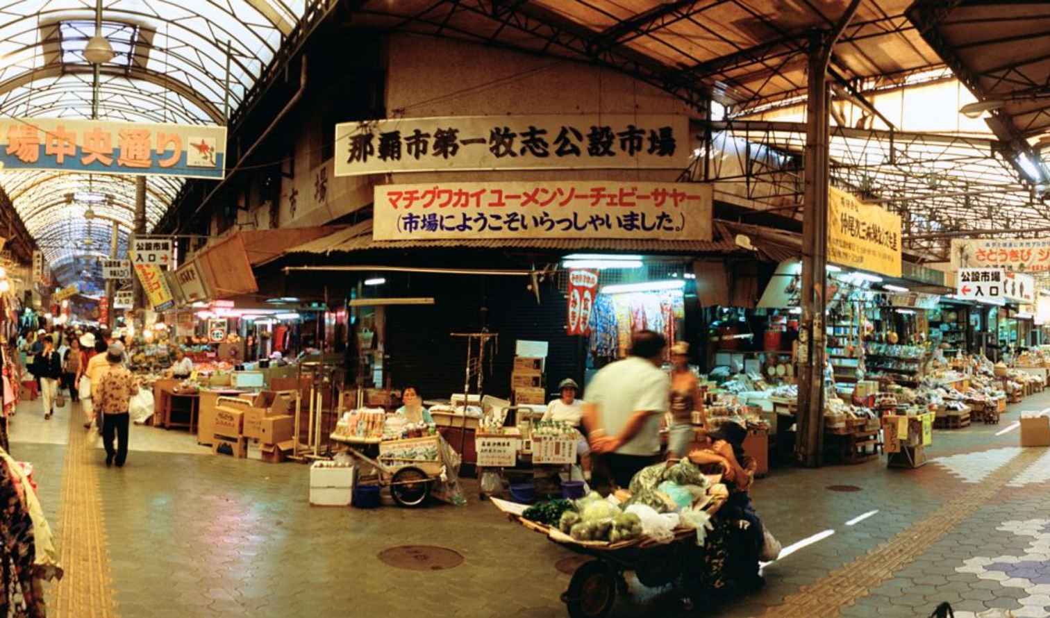 Shopping street in Naha Public Market, Okinawa, Japan with people walking.