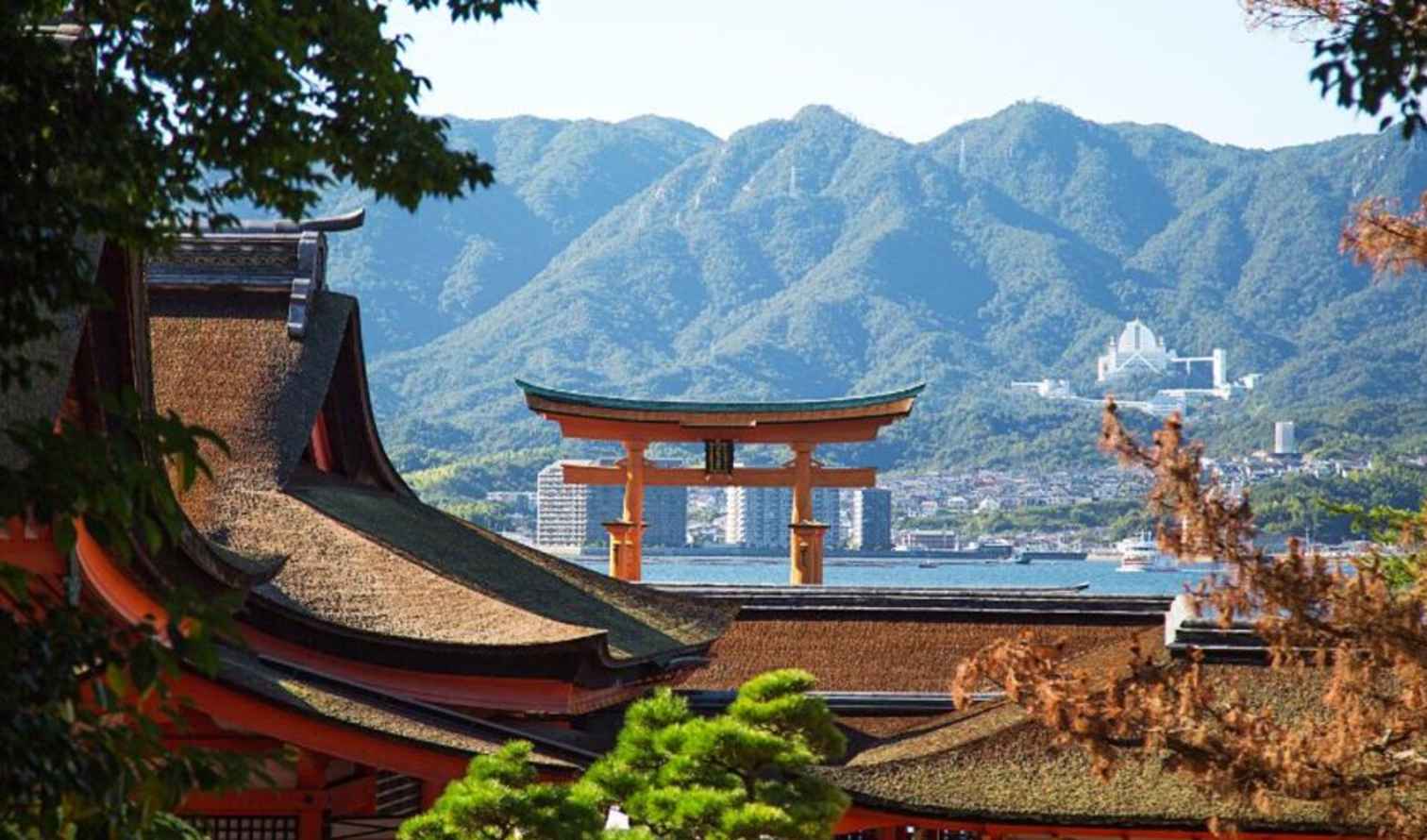 Mountainous backdrop behind the Itsukushima Shrine's rooftops in Nara