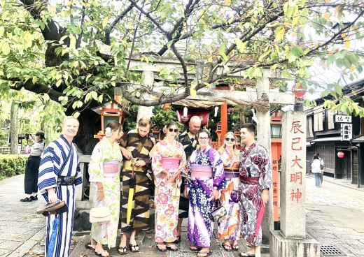 Cultural Harmony: Kimono-Clad Friends Amidst Ancient Toriis