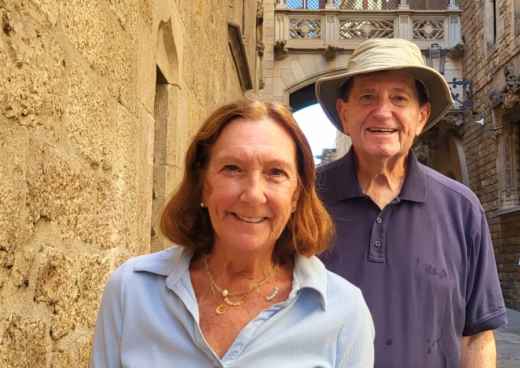 Strolling Through Time: A Joyful Pair in Historic Streets