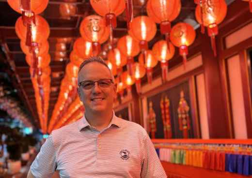 Illuminated Smiles Beneath a Sea of Red Lanterns