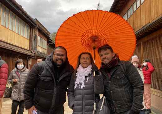Under the Vibrant Canopy: A Warm Moment Amidst Rainy Skies