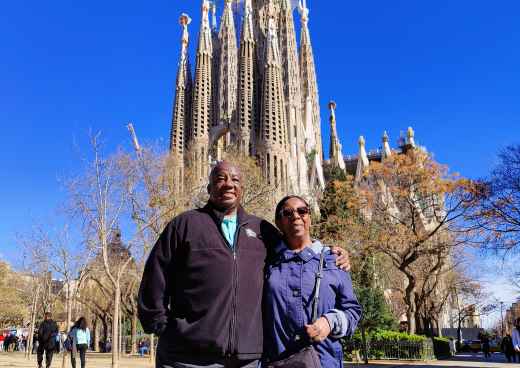 Two people pose in front of La Sagrada Família in Barcelona.