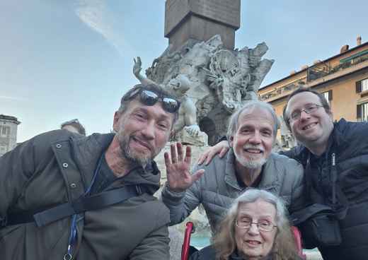 Four people standing in front of the Fountain of the Four Rivers, Rome.