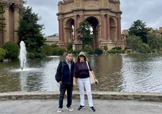 Couple posing near the water at the Palace of Fine Arts, San Francisco.