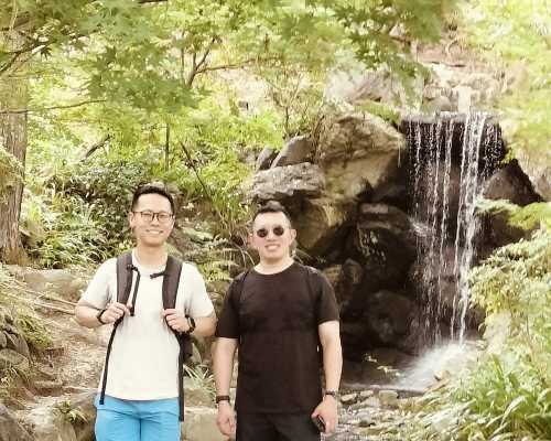 Whispers by the Waterfall: Friends in Nature's Embrace