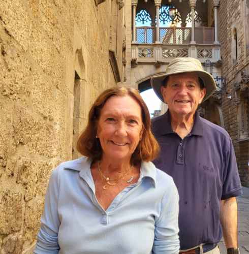 Strolling Through Time: A Joyful Pair in Historic Streets
