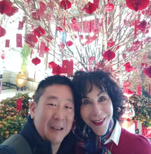 Blossoms and Smiles Amidst a Red Celebration