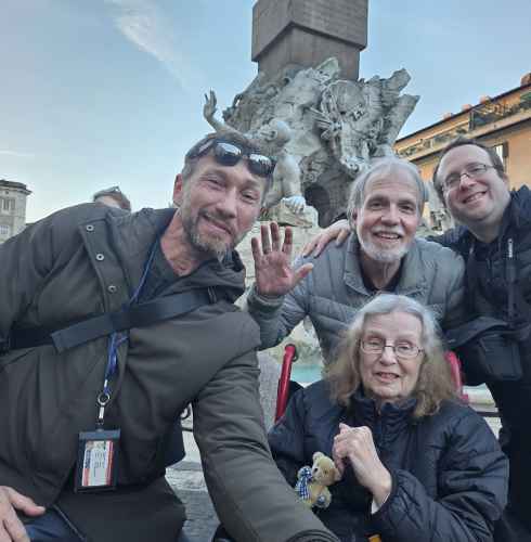 Four people standing in front of the Fountain of the Four Rivers, Rome.
