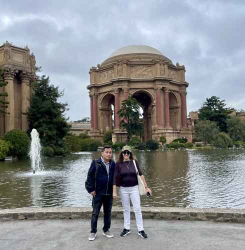 Couple posing near the water at the Palace of Fine Arts, San Francisco.