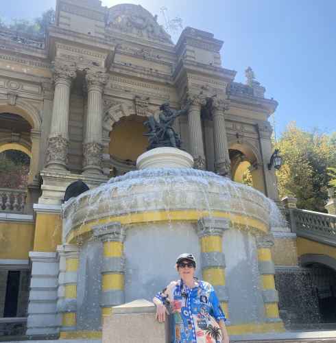 Person standing in front of the Fountain of Neptune, Santiago, Chile.