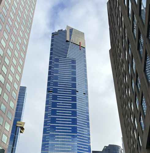 The Eureka Tower in Melbourne, visible between other skyscrapers.