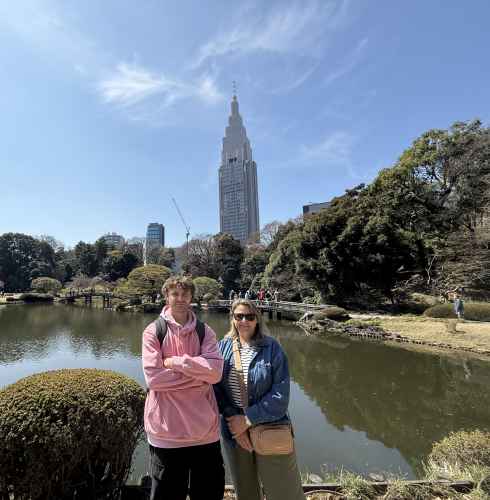 The NTT Docomo Yoyogi Building visible behind a pond.