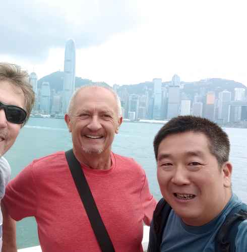 Three men taking a selfie in Hong Kong.
