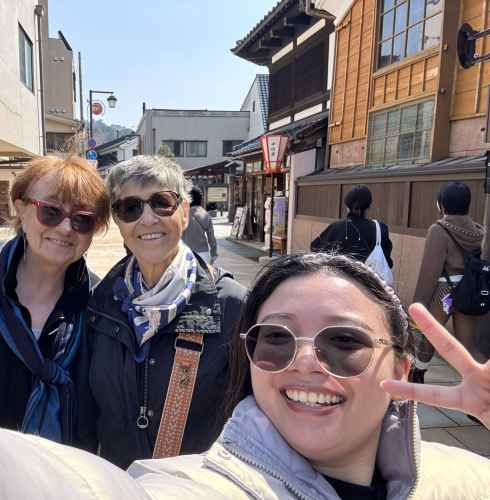 Group of three individuals in sunglasses in a Japanese district.