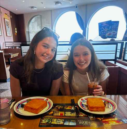 Sipping drinks and sharing smiles in a cozy Hong Kong café.