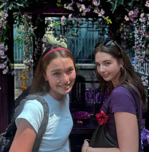 Tourists enjoying a sunny Hong Kong afternoon surrounded by vivid florals.