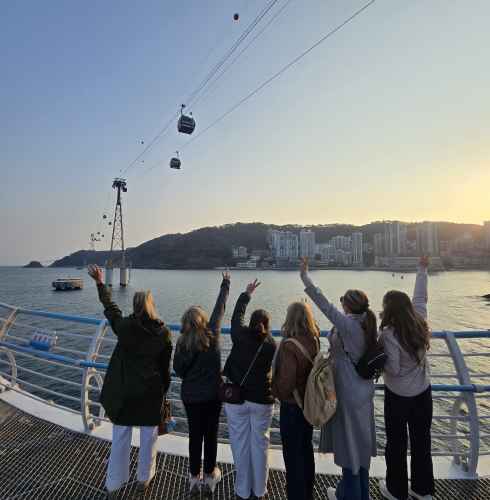 Reaching up to the sky, they embrace the sunset in Busan.
