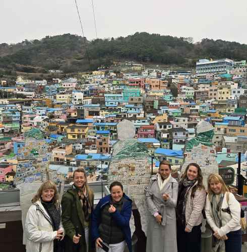 Sharing smiles against the colorful backdrop of Busan's hillside homes.