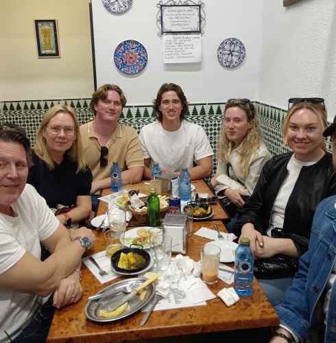A group savoring traditional bites in a charming Seville corner.