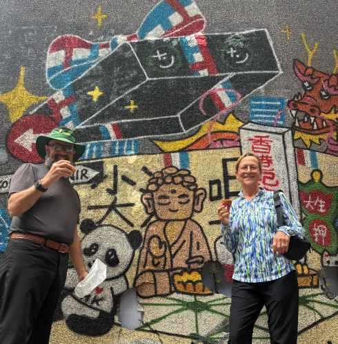 Colorful street art meets culinary delight on a lively day.