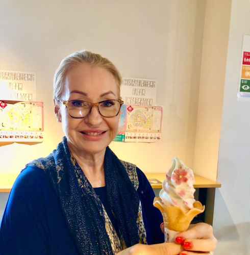 Tourist delighting in a cherry blossom ice cream moment in Osaka.