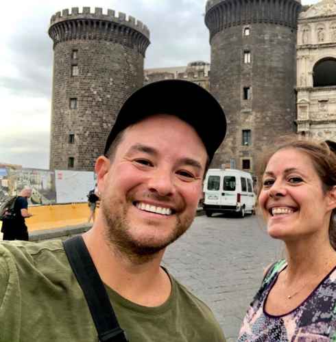 Sharing a smile outside the grand medieval fortress in Naples.
