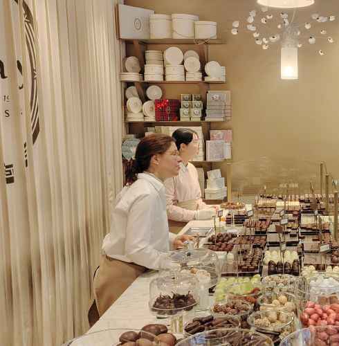 Decadent delights capture curious eyes inside a cozy Brussels shop.