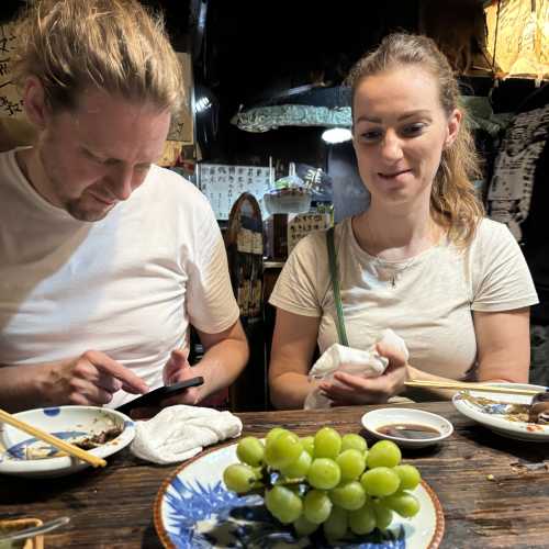 A Cozy Evening Feast: Friends and Fresh Grapes