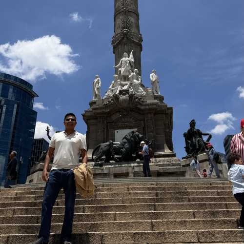 Guardian of Triumph: A Moment Beneath the Angel