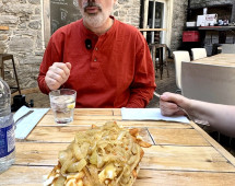 Savoring Poutine Delights in a Rustic Courtyard