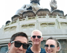 Standing in awe beneath timeless grandeur – a serene pause in a buzzing adventure.