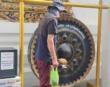 Curious Traveler at the Temple Gong
