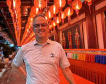 Illuminated Smiles Beneath a Sea of Red Lanterns