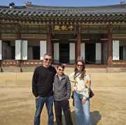 Visitors in casual attire at a historic palace entrance in South Korea.