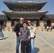 Individuals at Gwanghwamun Gate, the main entrance to Gyeongbokgung Palace.
