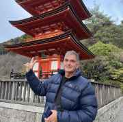 Man standing in front of the three-story pagoda at Kiyomizu-dera, Kyoto.