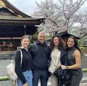 A cheerful group enjoys a cherry blossom moment in Kyoto.