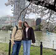 Cherry blossoms framing a serene Tokyo riverside walk.