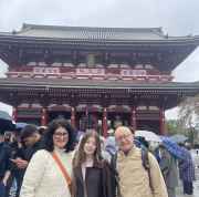 Travellers exploring historic wonders under a cloudy Tokyo sky.