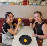 Tourists enjoying local treats in a cozy Singapore eatery.