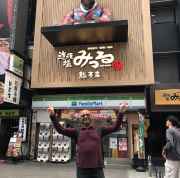 Celebrating a fun discovery in Osaka's bustling streets.