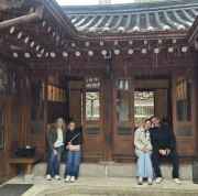 Warm smiles light up the hidden corners of a Seoul courtyard.