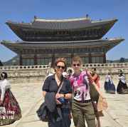 Traditional hanboks bring vibrant colors to the palace courtyard scene.