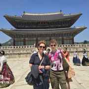 Traditional hanboks bring vibrant colors to the palace courtyard scene.