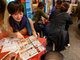 Local host showing guests a menu on a Kyoto food tour Local host showing guests a menu on a Kyoto food tour